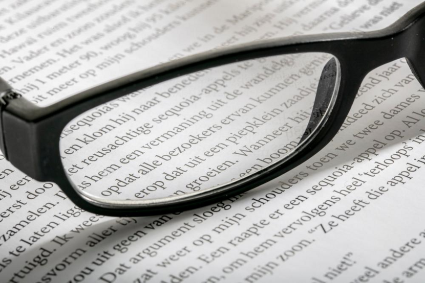 Leesbril op papier met tekst
